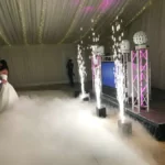 a white wedding venue with a tv on the floor, indoor spark streams