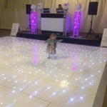 a kid dancing on the dance floor at a wedding