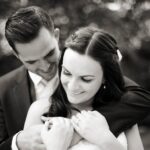 2 people looking at the camera smiling as they get married